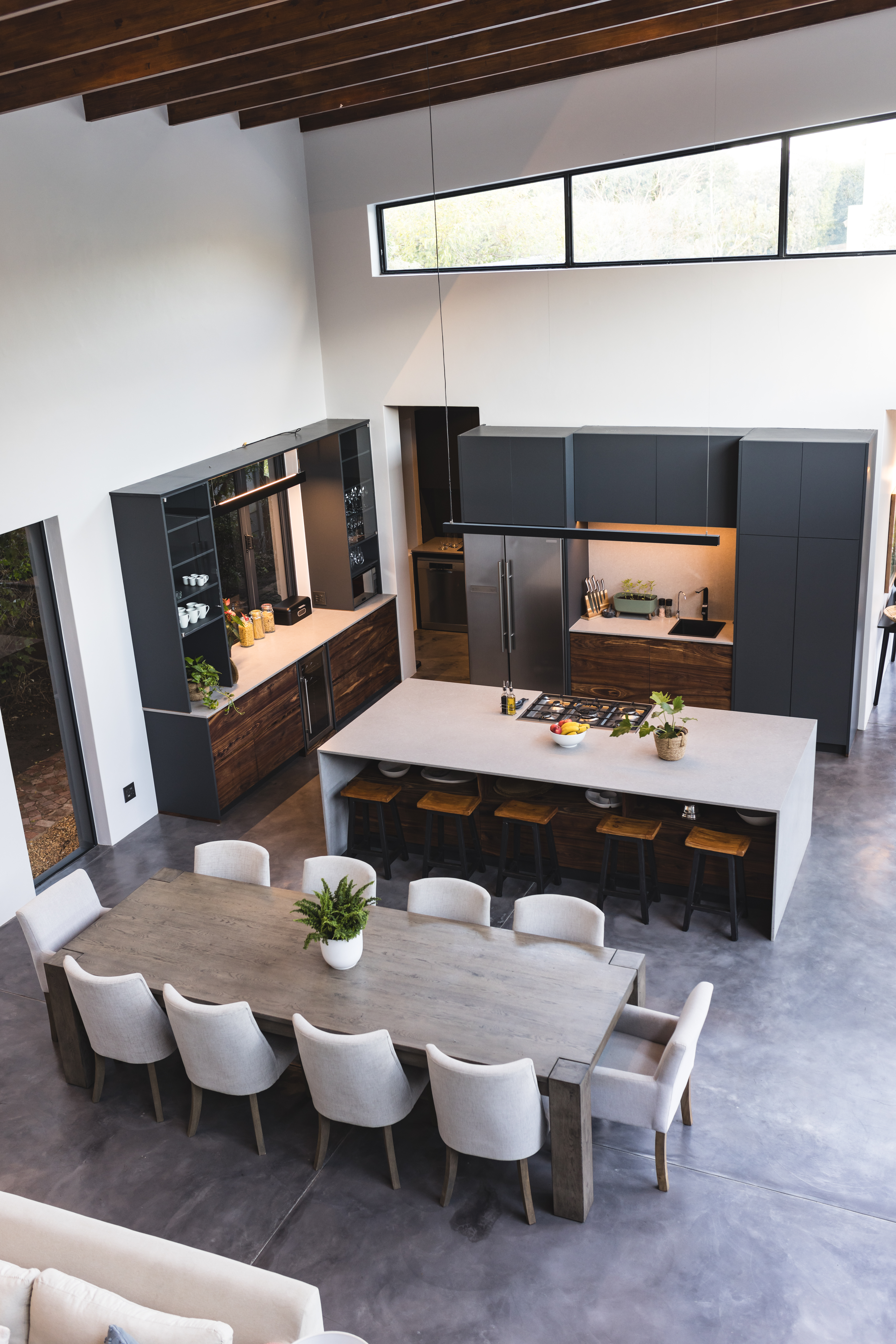 Modern kitchen and dining area with large table and stylish decor in home, copy space. Interior, furniture, contemporary, design, elegance, spacious